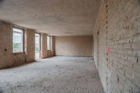 Entkernung in Potsdam-Krampnitz: Geschoss mit freigelegtem Mauerwerk, zurück auf den Rohbau
